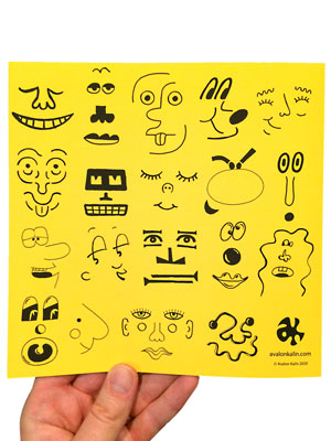 image of a hand holding a book. the book cover is the back of the book Face Finish by Avalon Kalin. it shows many finished faces in various cartoon and illustrative styles. 